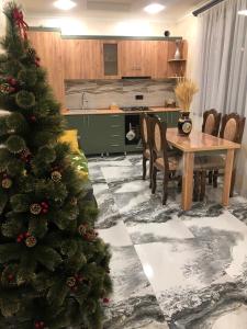 a christmas tree in a kitchen with a table and chairs at Baleni Guesthouse Agritourism in Gyulagarak