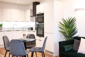 a kitchen with a table and chairs and a green couch at Free Parking Heart of Bristol City Stay in Bristol