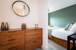 a bedroom with a dresser and a mirror at Free Parking Heart of Bristol City Stay in Bristol