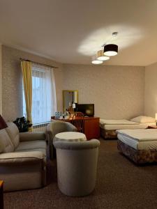 a room with couches and chairs and a television at Hotel Dana in Bytów +52 photos