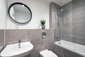 a bathroom with a sink and a toilet and a mirror at Free Parking Heart of Bristol City Stay in Bristol