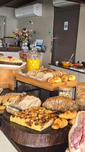 un buffet de diferentes tipos de panes y bollería en Hotel Sete Ilhas, en Florianópolis