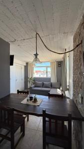 a living room with a table and a couch at Adeliz Playa in Santa Teresita