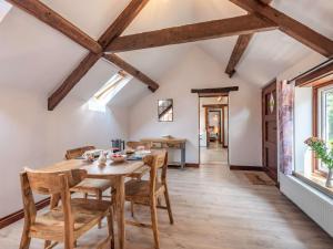 a dining room with a wooden table and chairs at 1 bed in Machynlleth 85207 in Darowen +13 photos