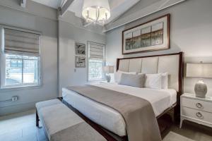 a bedroom with a large bed and a chandelier at Parker's Collection - 4 Bedroom in Savannah +40 photos