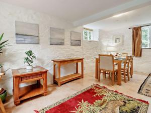 a living room with a table and a dining room at 3 Bed in Machynlleth 93083 in Cemmaes +14 photos