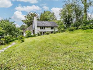 a house on top of a grassy hill at 3 Bed in Machynlleth 93083 in Cemmaes