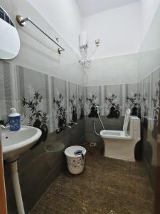 a bathroom with a sink and a toilet in it at Shri Durga Paradise in Tumkūr