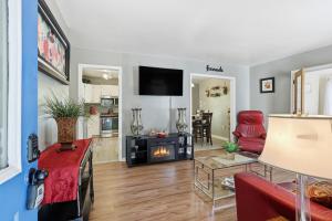 a living room with a red couch and a fireplace at Next Stop! Comfort! 3 BR Near Amtrak Station! in Richmond
