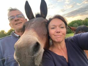 a woman and a man standing next to a horse at Gîte Le Jardin Secret Castanéa Parc Loire Anjou Touraine in Continvoir +10 photos