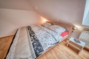 a small bedroom with a bed and a table at Rezidence Jih in Hlavňovice
