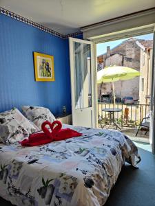 a bedroom with a bed with a bow on it at Chambres D'hôtes in Bains-les-Bains