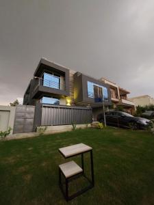 a house with a bench in the yard at The Oak Residence in Islamabad