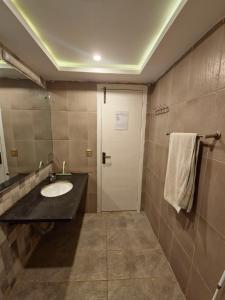 a bathroom with a sink and a mirror at The Oak Residence in Islamabad +33 photos