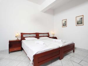 a bedroom with a large bed with white sheets at Villa Anna in Hanioti