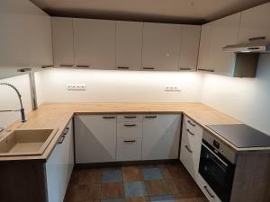 a kitchen with white cabinets and a sink at Rezidence Jih in Hlavňovice