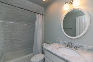 a bathroom with a sink and a mirror at Creekside Cottage in Edisto Island +35 photos