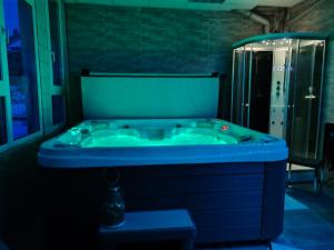 a bathroom with a blue tub in a dark room at Chambres D'hôtes in Bains-les-Bains +48 photos