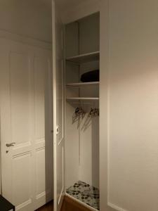 a closet with a white door and a pair of shoes at Laus-Angeles in Lausanne