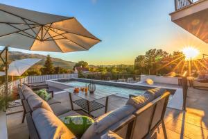 a patio with a table and chairs and a pool at Ferienhaus In Dugopolje Mit Privatem Pool in Dugopolje