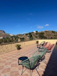 a group of chairs and tables on a patio at Hostal Boutique El Rey del Sol in Alora