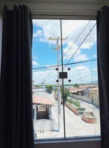 a window with a view of a street at AP Brisa do Rio in Galinhos +10 photos