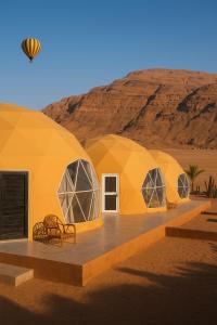 a group of domed tents in the desert at Desert Elegance Luxury Bedouin Camp Panoramic View in Disah