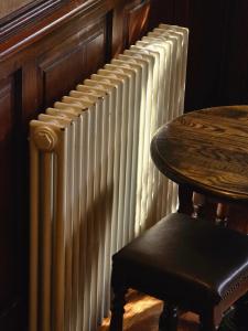 a chair sitting next to a radiator next to a table at Red Bull in Stockport
