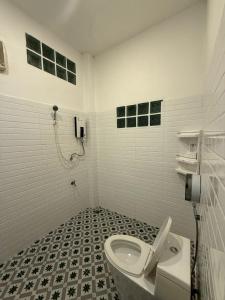 a bathroom with a toilet and a phone on the wall at SANDY HOUSE PAI 3bedroom in Kampong Huaibū