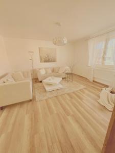 a living room with a couch and a table at Trio Apartments in Ostrava