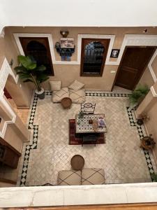 an overhead view of a living room with a table and chairs at Riad La Rose Des Sables in Marrakech +65 photos