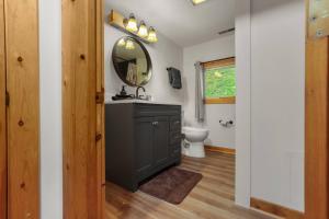 a bathroom with a sink and a mirror at Lakefront in Logan (In the heart of Hocking Hills) in Logan +27 photos