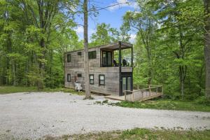 a tree house in the woods with a balcony at Hiltop Haven The Double Stack in Rockbridge