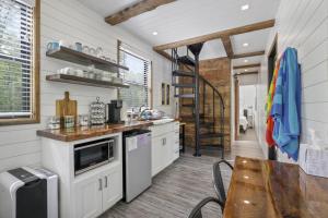 a kitchen with white cabinets and a staircase in a house at Hiltop Haven The Double Stack in Rockbridge