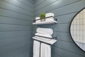 a blue bathroom with towels and a mirror at Hiltop Haven The Double Stack in Rockbridge +30 photos