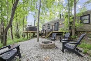 a cabin in the woods with benches and a fire pit at Hiltop Haven The Top Deck in Rockbridge