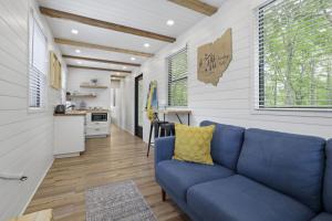 a living room with a blue couch and a kitchen at Hiltop Haven The Top Deck in Rockbridge