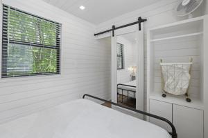 a white bedroom with a bed and a window at Hiltop Haven The Top Deck in Rockbridge