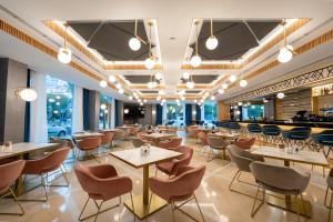 a restaurant with tables and chairs and a bar at Hotel Mezquita Center in Córdoba