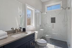 a bathroom with a shower and a toilet and a sink at Mountain View C - Mountain Stay, King Suite, Fireplace, and Mountain Views in Cullowhee +20 photos