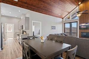 a kitchen and living room with a table and a couch at Mountain View C - Mountain Stay, King Suite, Fireplace, and Mountain Views in Cullowhee