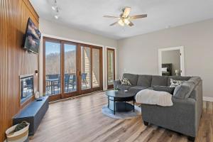 a living room with a couch and a table at Valley View C - Mountain Retreat, Cozy Balcony, and Grill in Cullowhee