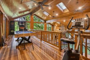 a game room with a pool table and a ceiling fan at Daisy Glen Retreat - Amazing Indoor Pool in South Bloomingville