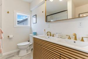 a bathroom with a sink and a toilet and a mirror at Gone Fishin in Buckeye Lake +35 photos