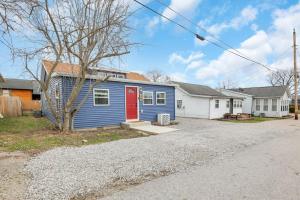 a blue and white house with a red door at Gone Fishin in Buckeye Lake