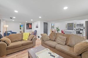 a living room with two brown couches and a kitchen at The Landing Spot in Summit Station