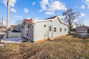 a small white house in a yard with a car at The Shack in Buckeye Lake