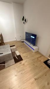 a living room with a flat screen tv on a wall at CCH comfort Bremerhaven in Bremerhaven