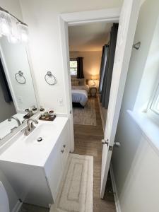 a bathroom with a sink and a mirror and a bed at Normandy Breeze in Wilmington +46 photos