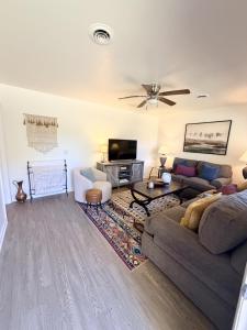 a living room with a couch and a tv at Normandy Breeze in Wilmington